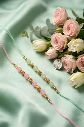 set of 2 pink & green artificial beads thread rakhi with roli chawal chandan mishri