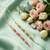 set of 2 pink & green artificial beads thread rakhi with roli chawal chandan mishri