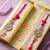 set of 2 red kundan studded floral design bhaiya bhabhi rakhi with roli chawal