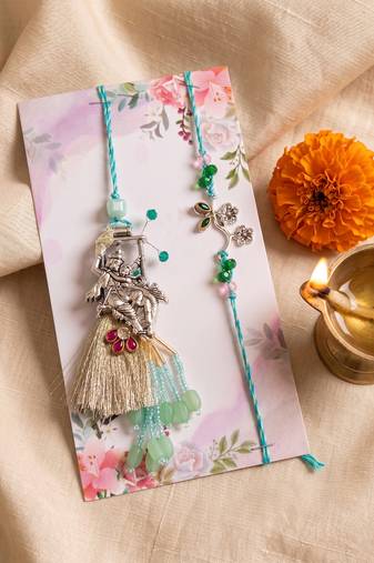 set of 2 designer religious silver toned bhaiya bhabhi rakhi with roli chawal chandan