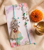 set of 2 designer religious silver toned bhaiya bhabhi rakhi with roli chawal chandan
