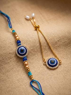 set of 2 blue evil eye gold toned bhaiya bhabhi rakhi with roli chawal chandan mishri 1