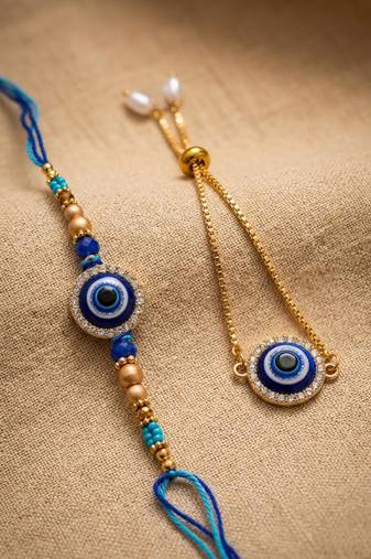 set of 2 blue evil eye gold toned bhaiya bhabhi rakhi with roli chawal chandan mishri