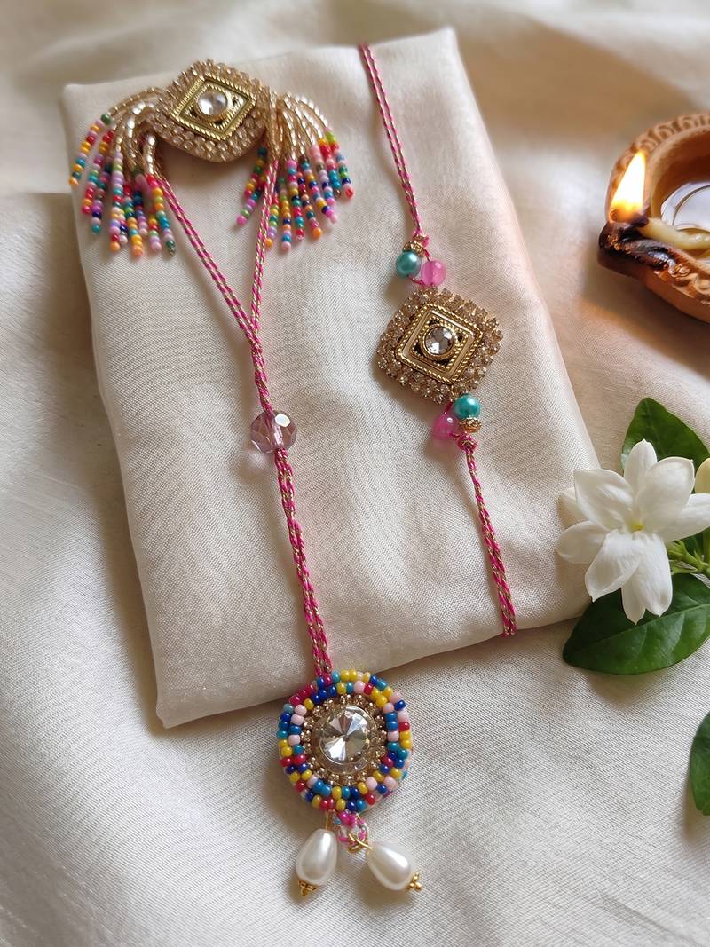 set of 2 white artificial stones golden toned bhaiya bhabhi rakhi with roli chawal
