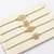 set of 4 white artificial stones & green thread rakhi with roli chawal chandan mishri