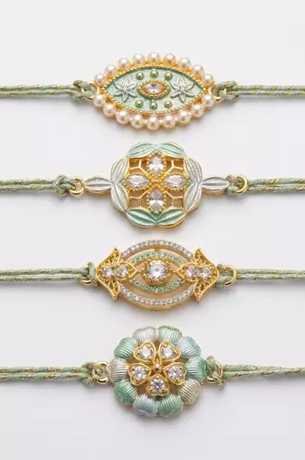 set of 4 white artificial stones & green thread rakhi with roli chawal chandan mishri