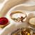 gold plated trishool design rudraksh rakhi bracelet with roli chawal chandan mishri