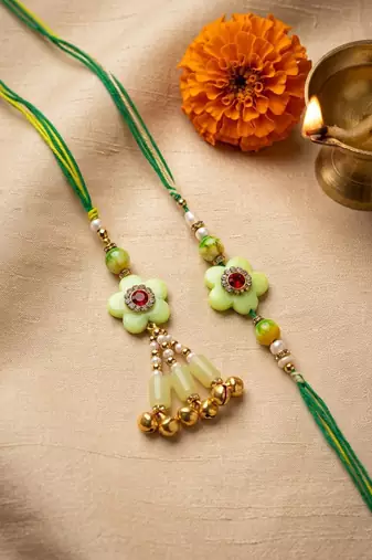 set of 2 flower shape artificial stones & beads bhaiya bhabhi rakhi with roli chawal