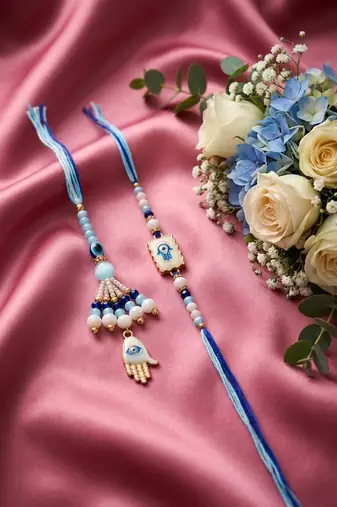 set of 2 evil eye hand design bhaiya bhabhi rakhi with roli chawal chandan mishri