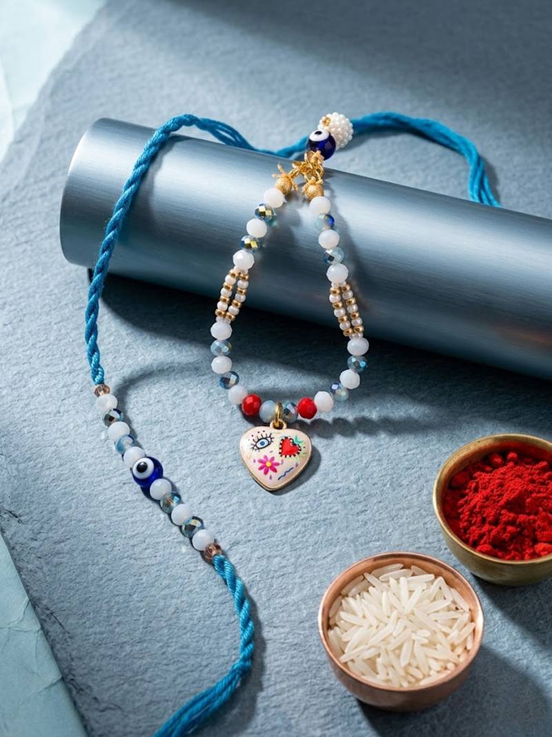 set of 2 evil eye beaded gold toned bhaiya bhabhi rakhi with roli chawal chandan