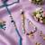 set of 2 evil eye beaded gold toned bhaiya bhabhi rakhi with roli chawal chandan