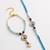set of 2 blue evil eye gold toned beaded bhaiya bhabhi rakhi with roli chawal chandan