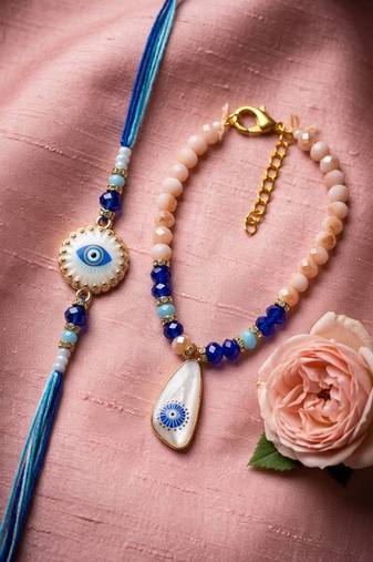 set of 2 gold toned evil eye beaded bhaiya bhabhi rakhi with roli chawal chandan