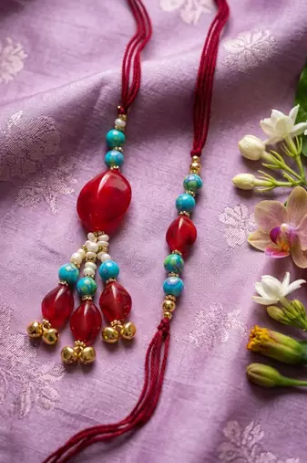 set of 2 artificial beads & gold toned ghungroo bhaiya bhabhi rakhi with roli chawal