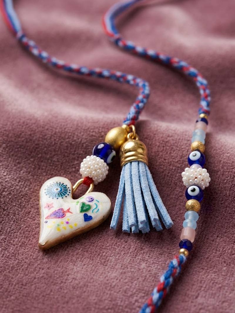 set of 2 evil eye beaded heart shape bhaiya bhabhi rakhi with roli chawal chandan