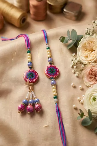 set of 2 artificial stones & beads floral design bhaiya bhabhi rakhi with roli chawal