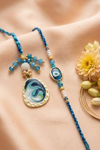 set of 2 blue evil eye traditional gold toned bhaiya bhabhi rakhi with roli chawal