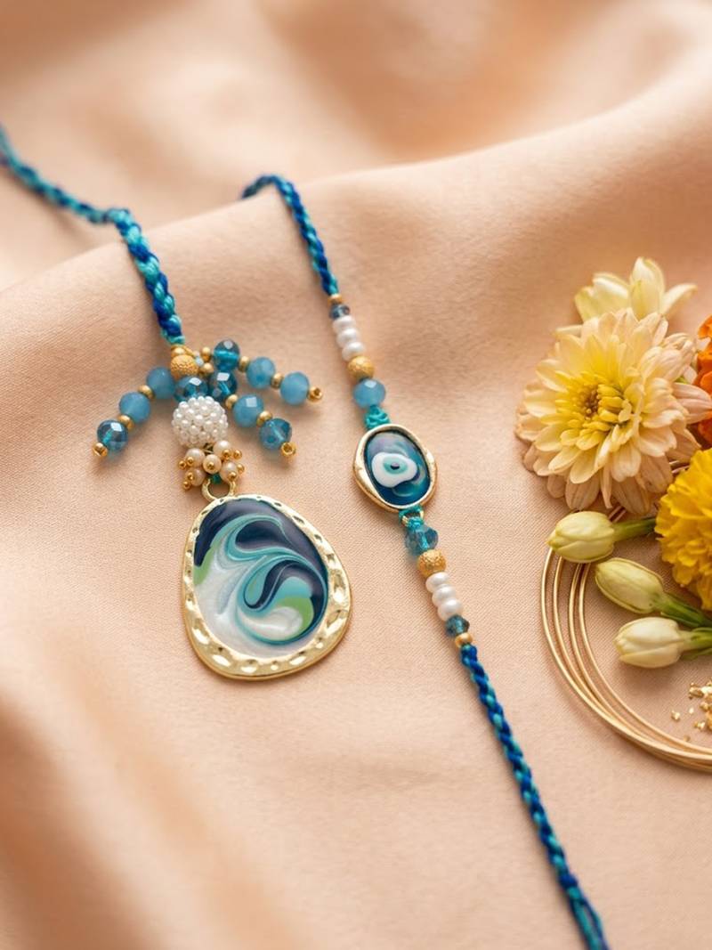 set of 2 blue evil eye traditional gold toned bhaiya bhabhi rakhi with roli chawal