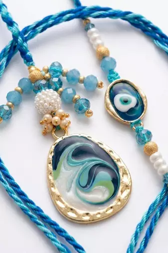 set of 2 blue evil eye traditional gold toned bhaiya bhabhi rakhi with roli chawal