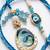 set of 2 blue evil eye traditional gold toned bhaiya bhabhi rakhi with roli chawal