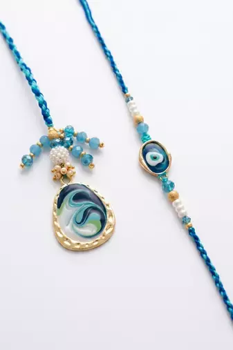 set of 2 blue evil eye traditional gold toned bhaiya bhabhi rakhi with roli chawal