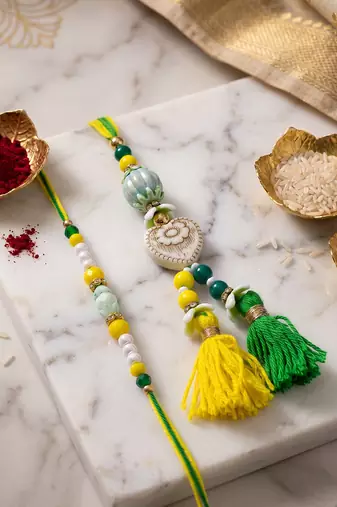 set of 2 green & yellow beaded heart shape bhaiya bhabhi rakhi with roli chawal