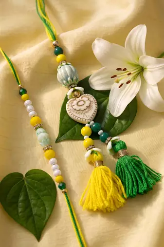 set of 2 green & yellow beaded heart shape bhaiya bhabhi rakhi with roli chawal