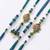 set of 4 green peacock design artificial beads thread rakhi with roli chawal