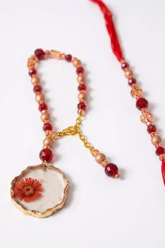 set of 2 gold toned red artificial beads bhaiya bhabhi rakhi with roli chawal chandan