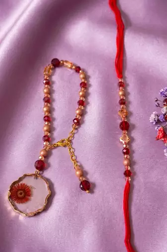 set of 2 gold toned red artificial beads bhaiya bhabhi rakhi with roli chawal chandan