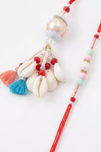 set of 2 multicolor artificial beads & sea shell bhaiya bhabhi rakhi with roli chawal