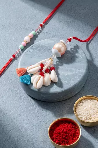 set of 2 multicolor artificial beads & sea shell bhaiya bhabhi rakhi with roli chawal