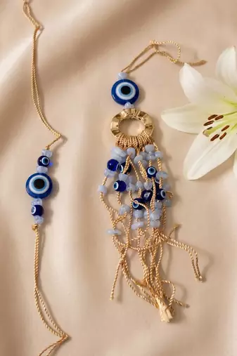 set of 2 gold toned round evil eye bhaiya bhabhi rakhi with roli chawal chandan mishri