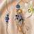 set of 2 gold toned round evil eye bhaiya bhabhi rakhi with roli chawal chandan mishri