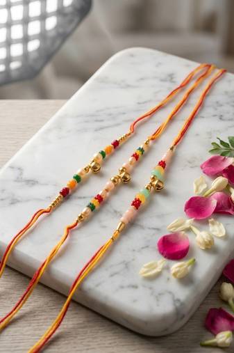 set of 3 artificial beads orange thread rakhi with roli chawal chandan mishri
