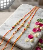 set of 3 artificial beads orange thread rakhi with roli chawal chandan mishri