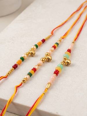 set of 3 artificial beads orange thread rakhi with roli chawal chandan mishri 2