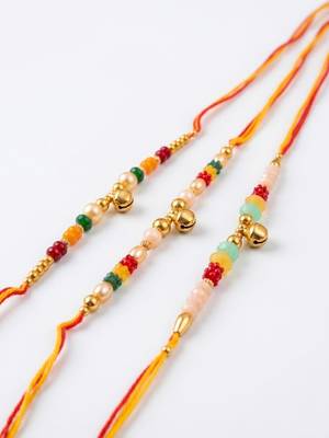 set of 3 artificial beads orange thread rakhi with roli chawal chandan mishri 3