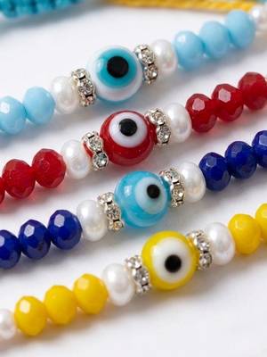 set of 4 multicolor evil eye thread rakhi with roli chawal chandan mishri 4