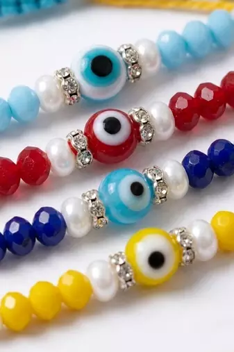 set of 4 multicolor evil eye thread rakhi with roli chawal chandan mishri