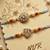 set of 2 gold toned artificial stones & beads thread rakhi with roli chawal chandan