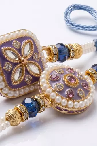 set of 2 white pearls thread rakhi with roli chawal chandan mishri