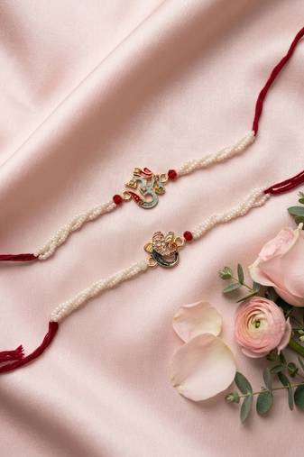 set of 2 white pearls om & ganesh ji thread rakhi with roli chawal chandan mishri