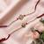 set of 2 white pearls om & ganesh ji thread rakhi with roli chawal chandan mishri