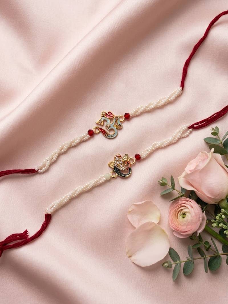 set of 2 white pearls om & ganesh ji thread rakhi with roli chawal chandan mishri