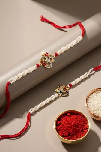 set of 2 white pearls om & ganesh ji thread rakhi with roli chawal chandan mishri