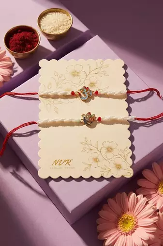 set of 2 white pearls om & ganesh ji thread rakhi with roli chawal chandan mishri