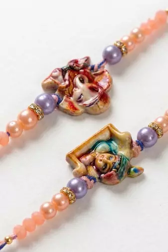 set of 2 krishna ji & ganesh ji beaded religious thread rakhi with roli chawal