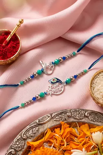 set of 2 silver toned beaded religious thread rakhi with roli chawal chandan mishri