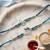 set of 2 silver toned beaded religious thread rakhi with roli chawal chandan mishri